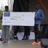 Meru Governor Kiraitu Murungi hands over a dummy cheque worth Sh500,000 to Patrick Kipng’eno