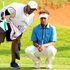 Njoroge Kibugu lines up his putt at the 18th hole green with his caddie Bo Ciera during Magical Kenya Open