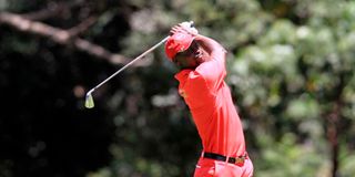 David Wakhu follows the progress of his shot from 18th hole fairway during Magical Kenya Open 