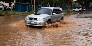 A motorist drives in floods in Nairobi