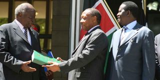 President Mwai Kibaki (left) receives the Waki report