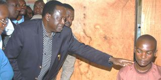 ODM leader Raila Odinga comforts a PEV victim