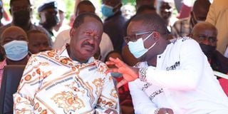 Raila Odinga (left) and Suna West MP Peter Masara 