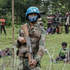 A peacekeeper protects civilians who fled violent clashes