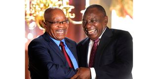 South Africa's President Cyril Ramaphosa shakes hands with his predecessor Jacob Zuma 
