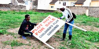 Residents of Akiba Estate in South C erect a signage on a piece of land set side as a children’s playground