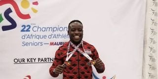 Ferdinand Omanyala poses with his gold medal 