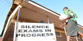 A KCSE invigilator enters an exam hall at Uasin Gishu High School