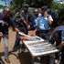 Police in Kisii display machetes seized on June 12.