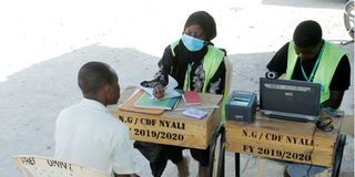 A man registers as a voter at Kwa Bulo Primary School in Mombasa
