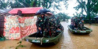 Bangladesh army personnel evacuate affected people from a flooded area
