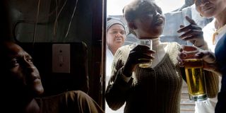 Men and women drink in a shebeen in South Africa