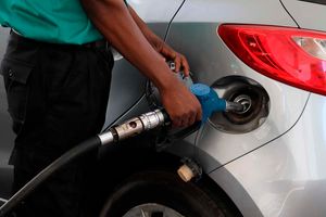 An attendant at a petrol station in Nairobi fuels a customer’s car
