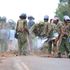 Anti-riot police remove boulders placed on the road by protesters along Kisii - Kilgoris road.