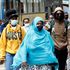 People wearing masks walk in a Nairobi street.