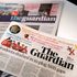 The new look tabloid Guardian next to the old broadsheet version.