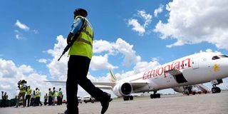 A police officer walks past an Ethiopian Airline plane at the Jomo Kenyatta International Airport.