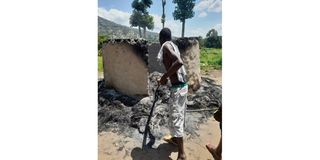 Man stares at the shell of his house in Kapsiren village, Marakwet East sub-county. Police burnt down houses in an operation.
