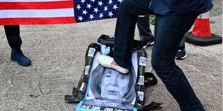 A pro-Beijing protester stamps on an image depicting the US House Speaker Nancy Pelosi 