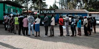 People wait in line to change their voting constituency for the General Election scheduled on August 9 at Kibra Constituency.