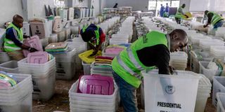 An IEBC official cleans ballot boxes and electoral material at a tallying centre in Nairobi.