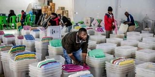 An IEBC official cleans ballot boxes and electoral materials at a tallying centre in Nairobi.