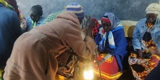 Elderly women warming their hands at Turesia polling polling in Keiyo South constituency on August 9, 2022