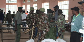 Police officers assigned at St Monica Girls tallying centre in Kwanza constituency