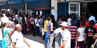 Members of the public queue outside A-ONE Supermarket along Digo Road in Mombasa County.