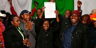 Embu governor-elect Cecily Mbarire (centre) holds up her certificate after being declared the winner.
