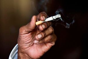 An Indian man smokes a cigarette in New Delhi.