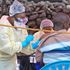 A young boy gets a vaccine jab against Ebola.