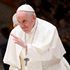 Pope Francis waves to pilgimsat Paul-VI hall in The Vatican.