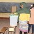 A voter casting her ballot at Mercy Njeri Primary School 