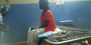 A patient at Lodwar County Referral Hospital on a bed without a mattress on August 28, 2022.