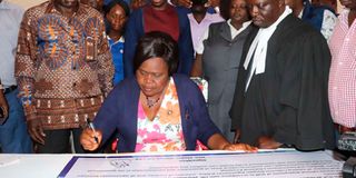 Homa Bay Woman Representative Gladys Wanga signs a health charter.