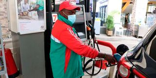 A filling station attendant fueling a car.