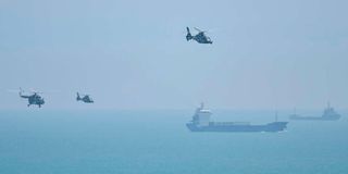 Chinese military helicopters fly past Pingtan island