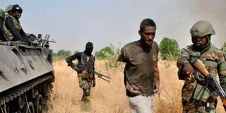 Nigerian soldiers capture a terrorist after an operation against Boko Haram terrorists.
