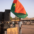 A man holds a Burkina's flag during a gathering to show support to the military