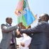 Former Laikipia Governor Ndiritu Muriithi hands a flag to his successor Joshua Irungu.