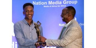 NMG Chairman Dr Wilfred Kiboro awards fifth leg winner Kevin Kabugi