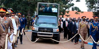 President Uhuru Kenyatta is pulled by high-ranking military officers.
