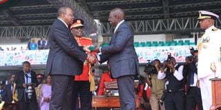 President William Ruto when being handed the instruments of power by former President Uhuru Kenyatta.