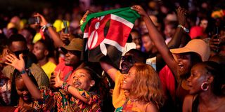 An Nyege Nyege festival-goer waves the Kenyan flag