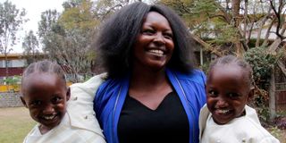 Carol Mukiri with her seven-year-old identical twins Favour Karimi and Blessings Kathure.