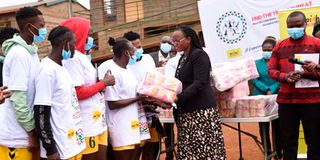 Health PS Susan Mochache distributing sanitary pads to girls at Mathare Youth Sports Association Grounds