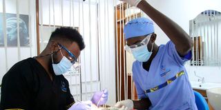 Simon Njoroge (right) assists Dr Peter Jackson Muriuki during a prophylaxis procedure.