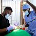 Simon Njoroge (right) assists Dr Peter Jackson Muriuki during a prophylaxis procedure.