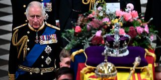 Britain's King Charles III walks beside the coffin of Queen Elizabeth II.